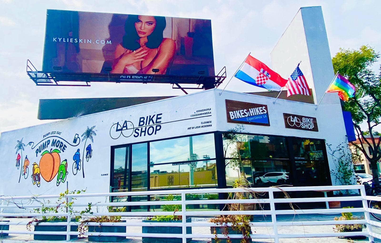 a bike shop in los angeles beneath a large billboard featuring an image of kylie jenner