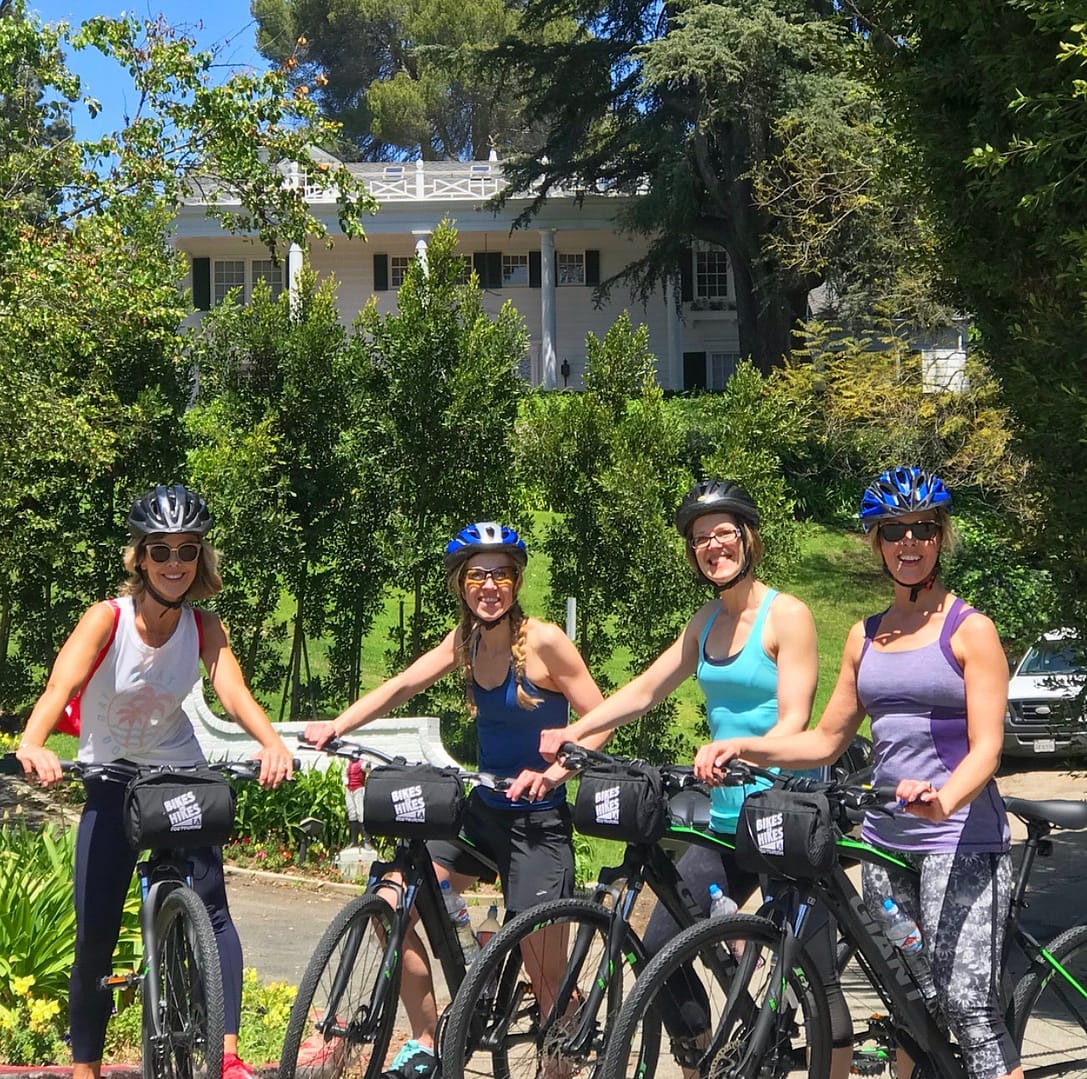 four people in front of a movie star home in bel air on la bike rentals