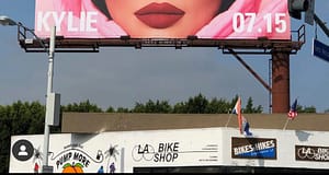 a photo of kylie jenner on a billboard above a los angeles bike shop